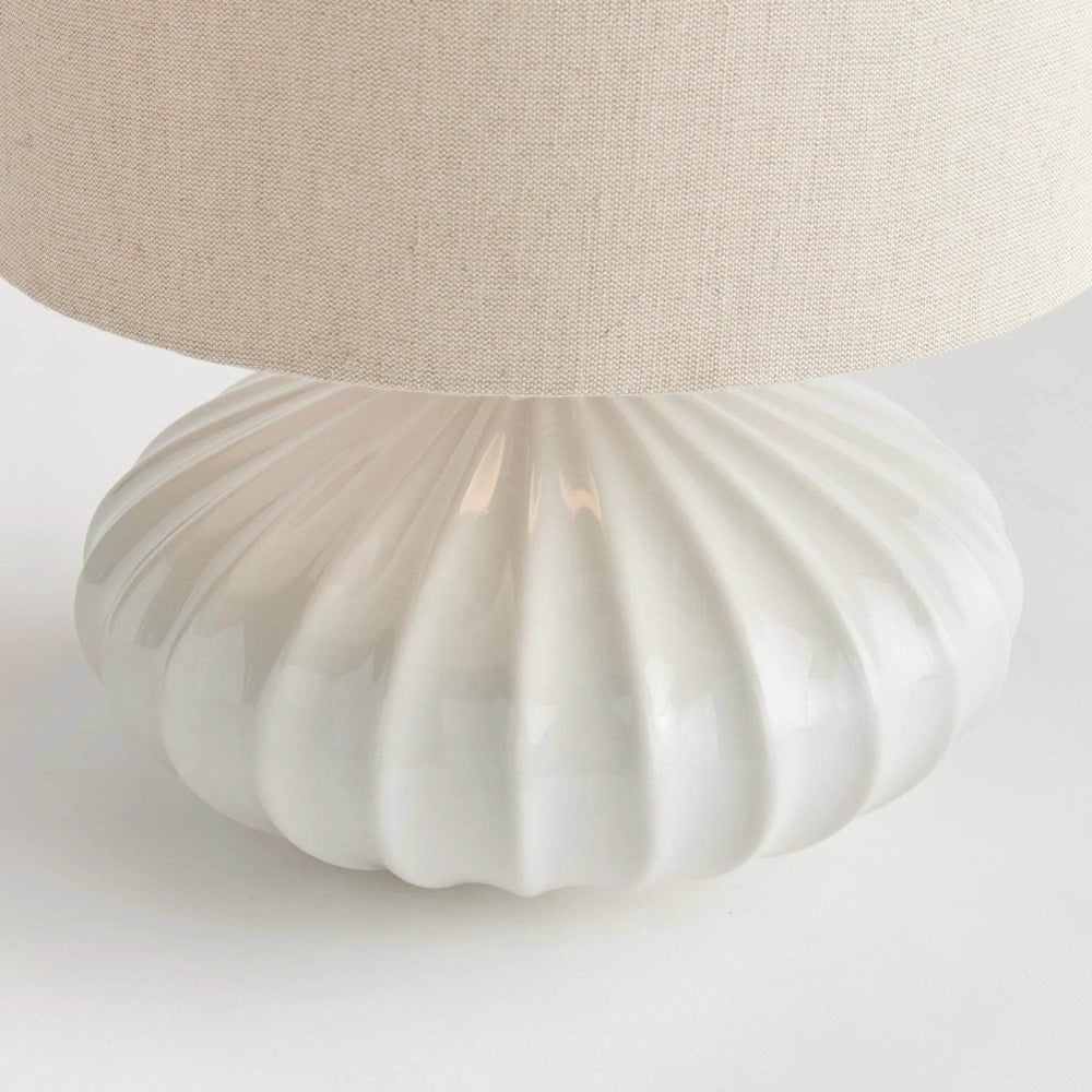 Crafted with intricate detail, the Lillet White Table Lamp boasts a curved ceramic base that sets it apart. Its grand scale and sweeping design make it a striking focal point in any transitional space. Unique, versatile, and elegant, this table lamp is a must-have for any lighting enthusiast.