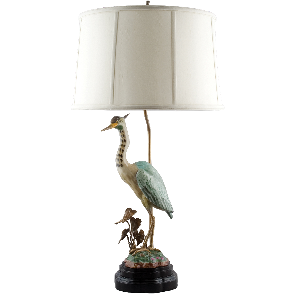 This sophisticated porcelain heron table lamp adds a touch of elegance to any living room. Featuring natural tones and a beautiful bird statuary, this lamp is adorned with a bronze ormolu and paired with a complementary lamp shade. Perfect for adding a unique touch to your home decor.