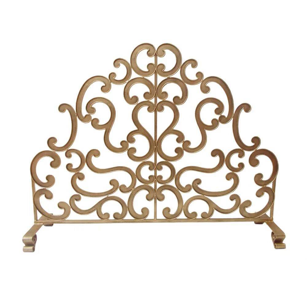 Antique gold decorative fire screen with intricate scroll detailing, freestanding in front of a traditional hearth, coastal style.