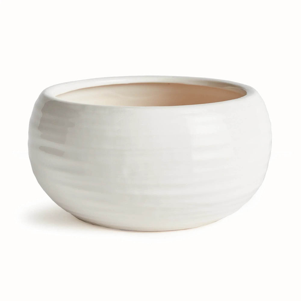 Top view of handcrafted stoneware bowl with unglazed natural clay interior and glossy oatmeal exterior glaze.