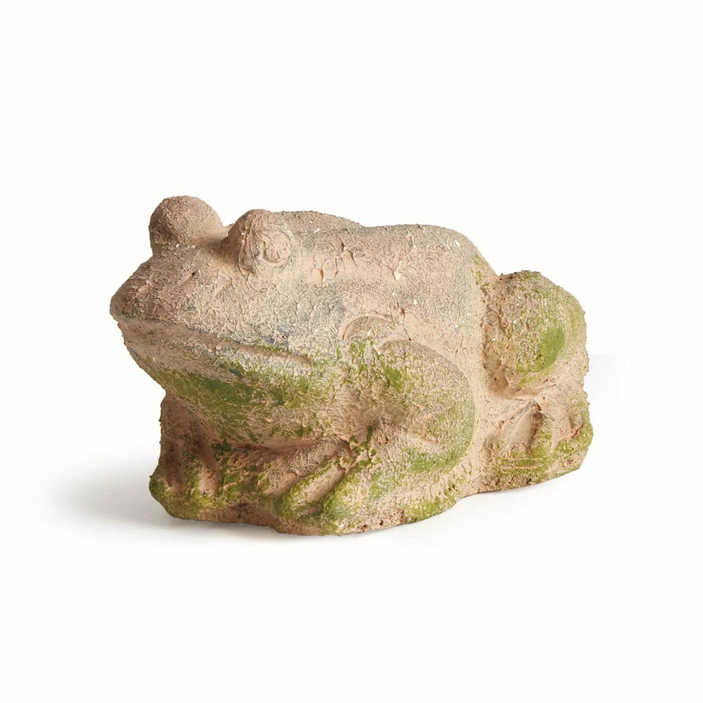 Rustic terracotta garden frog statue with mossy green accents, shown from the side to highlight aged surface texture.