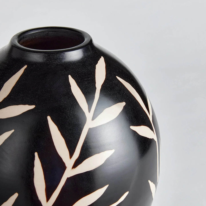 Close-up of etched vine pattern on matte black terracotta vase showing texture and contrast – Modern Organic.