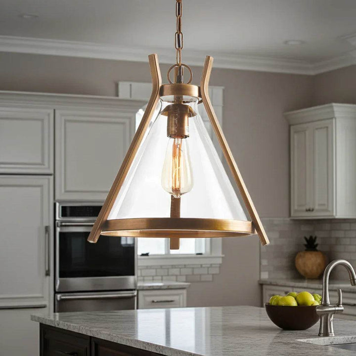 Brass and glass industrial pendant light installed above kitchen island, adding focused task lighting in modern culinary space