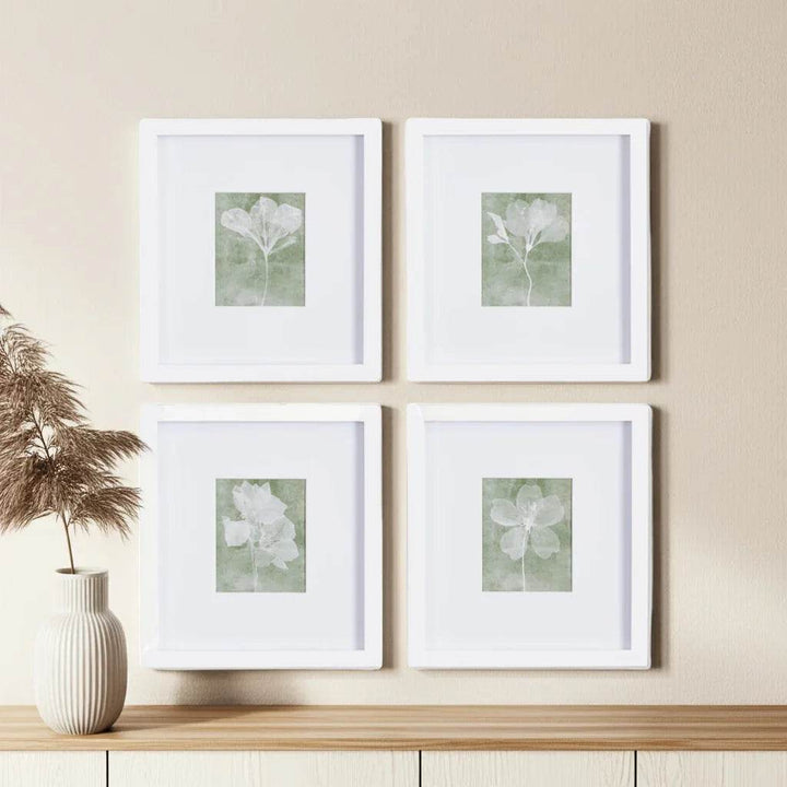 White frame wall art with translucent flowers styled in organic grid with ceramic vases