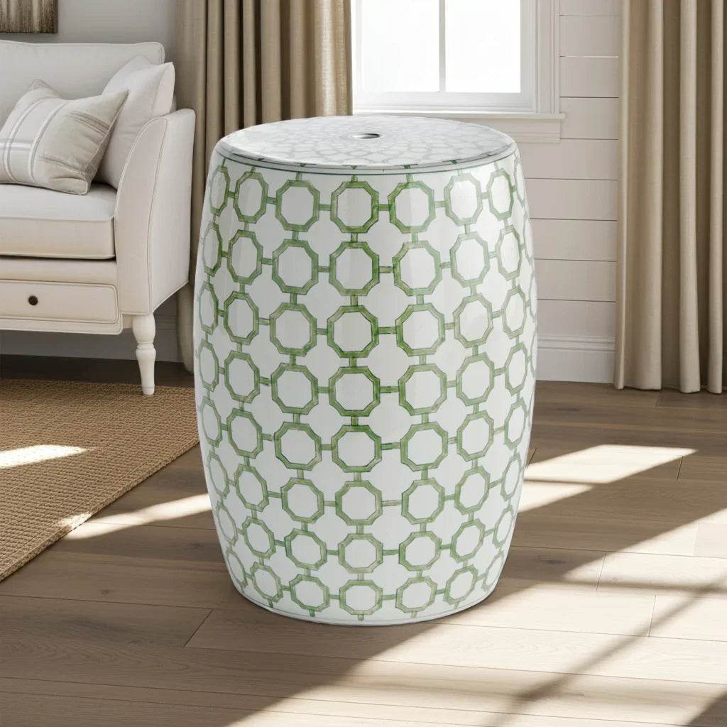Chinoiserie porcelain garden stool placed near chair and drapes, elegant accent in light-filled room.