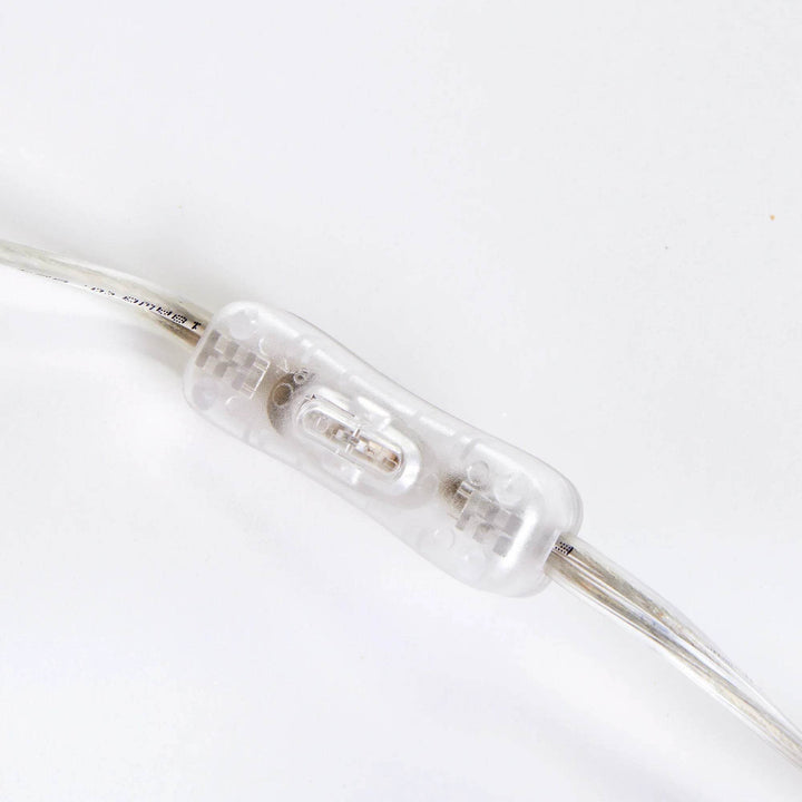 Transparent cord switch detail on hammered brass table lamp