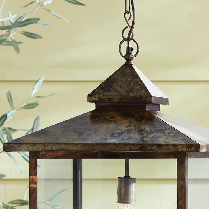 Close-up of Heritage Rustic lantern top showing weathered iron peak and hanging hardware detail.