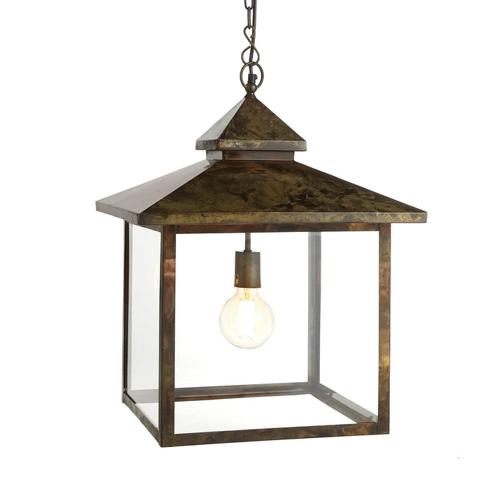 Hanging outdoor lantern with glass panels and aged iron finish in Heritage Rustic style, shown front-facing.