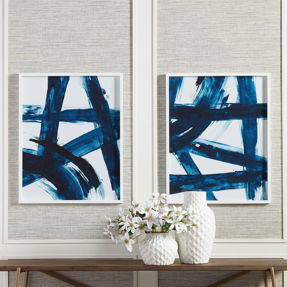 Framed modern abstract wall art set styled above entryway console with ceramic vases