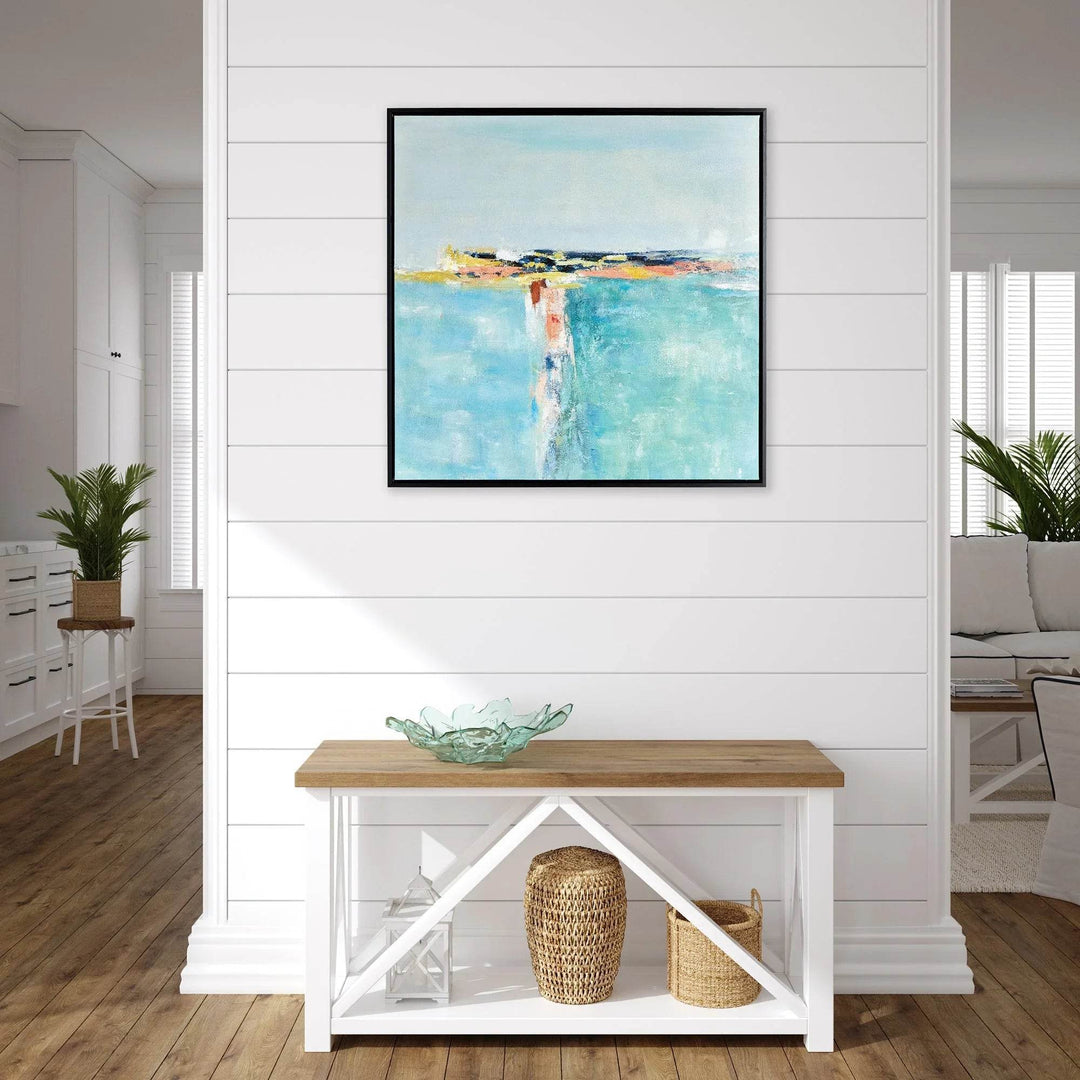 Modern coastal wall art canvas over entryway console with seagrass accents and shiplap backdrop for breezy coastal styling.