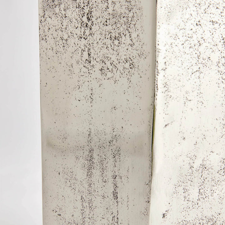 Close-up texture of cast aluminum surface with distressed silver and blackened finish