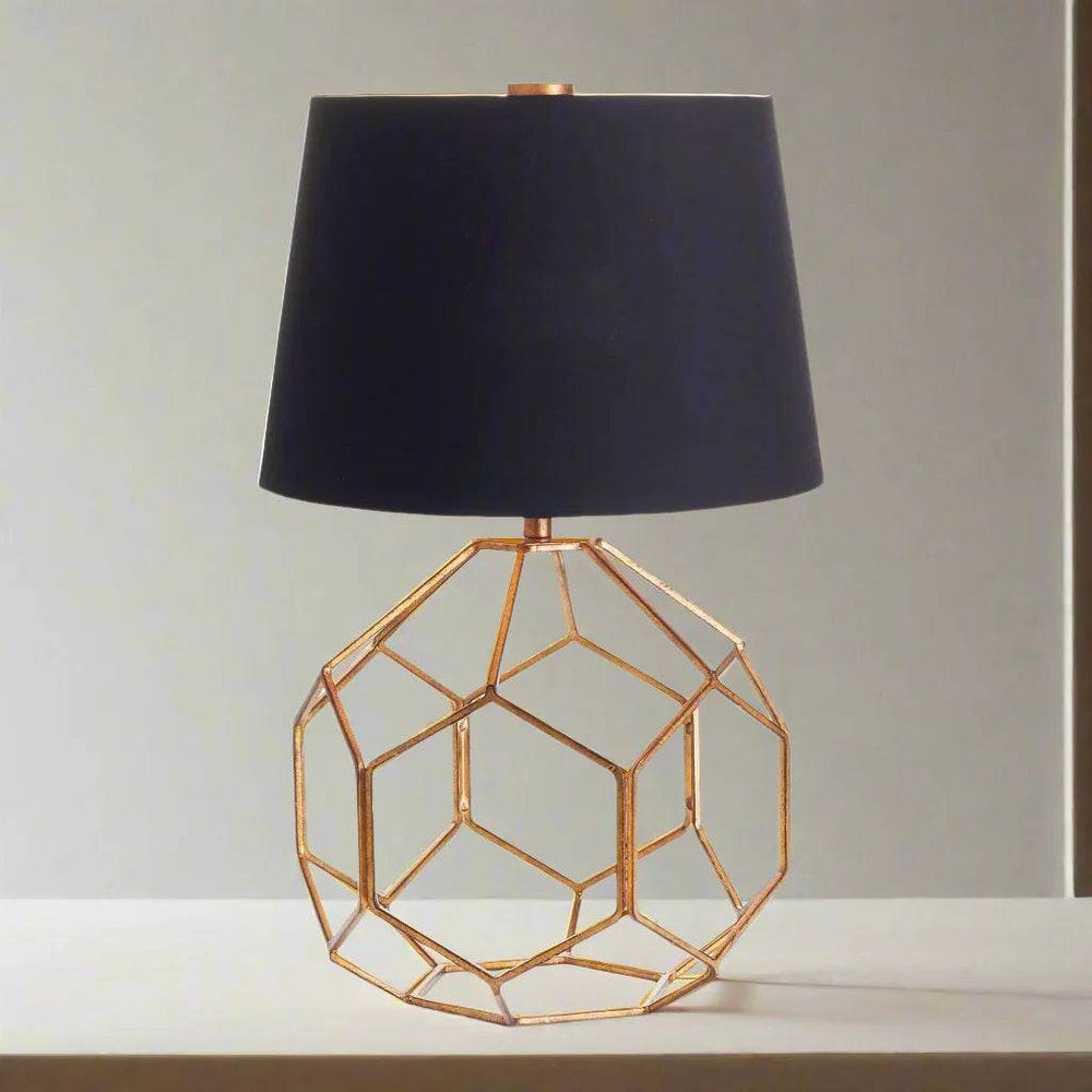 Modern brass table lamp with black shade in softly lit neutral space