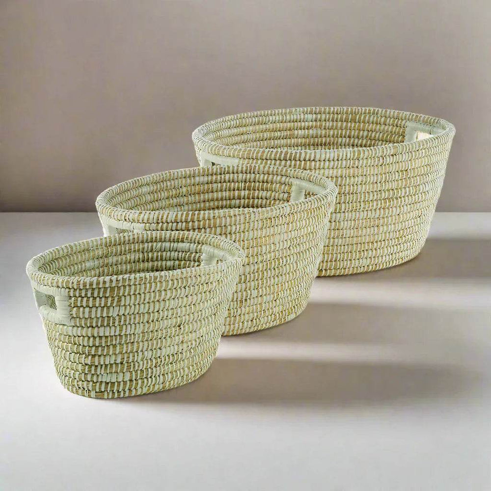 Handwoven rivergrass baskets with built-in handles shown nested, ideal for modern organic home organization.
