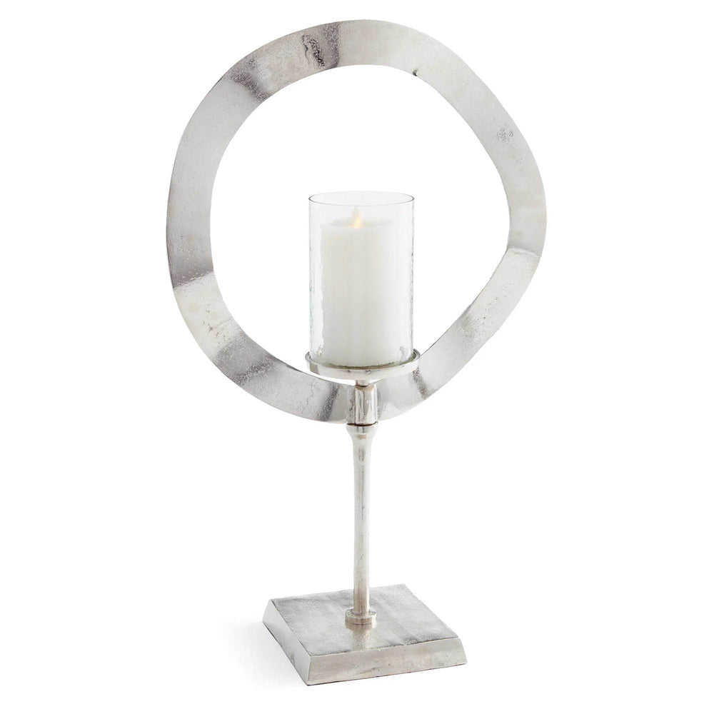 Tall silver candle stand with glass hurricane shown on white background, sculptural metal candle holder for home styling – Minimalist Glam.