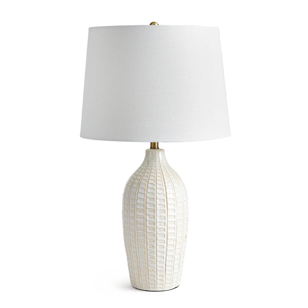 Tall white ceramic table lamp with brass accents and fabric shade, front-facing product view