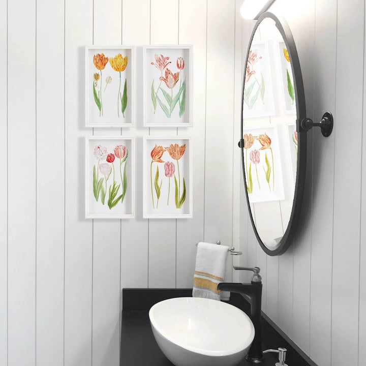 Tulip wall art set arranged in a white-paneled bathroom beside a round mirror and black faucet – Cottage Garden