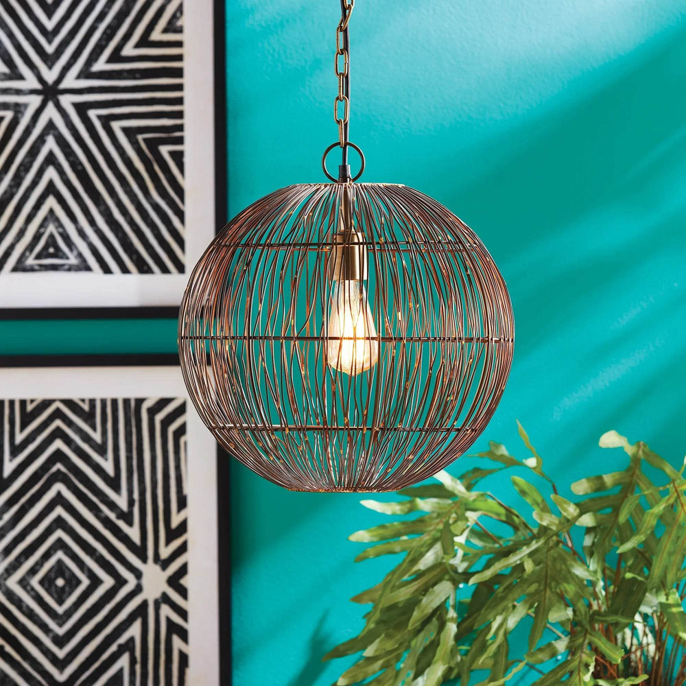 Unique modern hanging light with iron wire frame and visible bulb against turquoise wall.