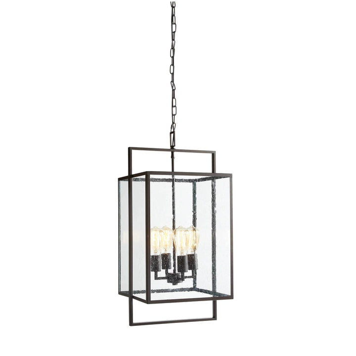 Urban Loft pendant light in oil-rubbed bronze with seeded glass and geometric frame, ideal for entryways, halls, or dining areas.