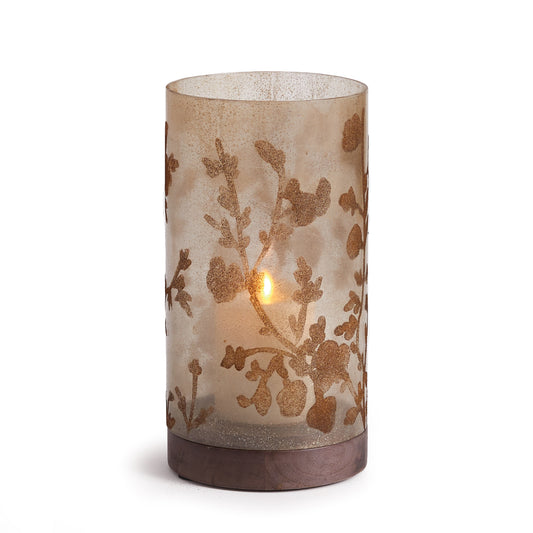 A flowing vine motif twists and turns around speckled, smoky glass. This simple hurricane sits atop a gray turned wood Base. A beautiful accent for home or office.