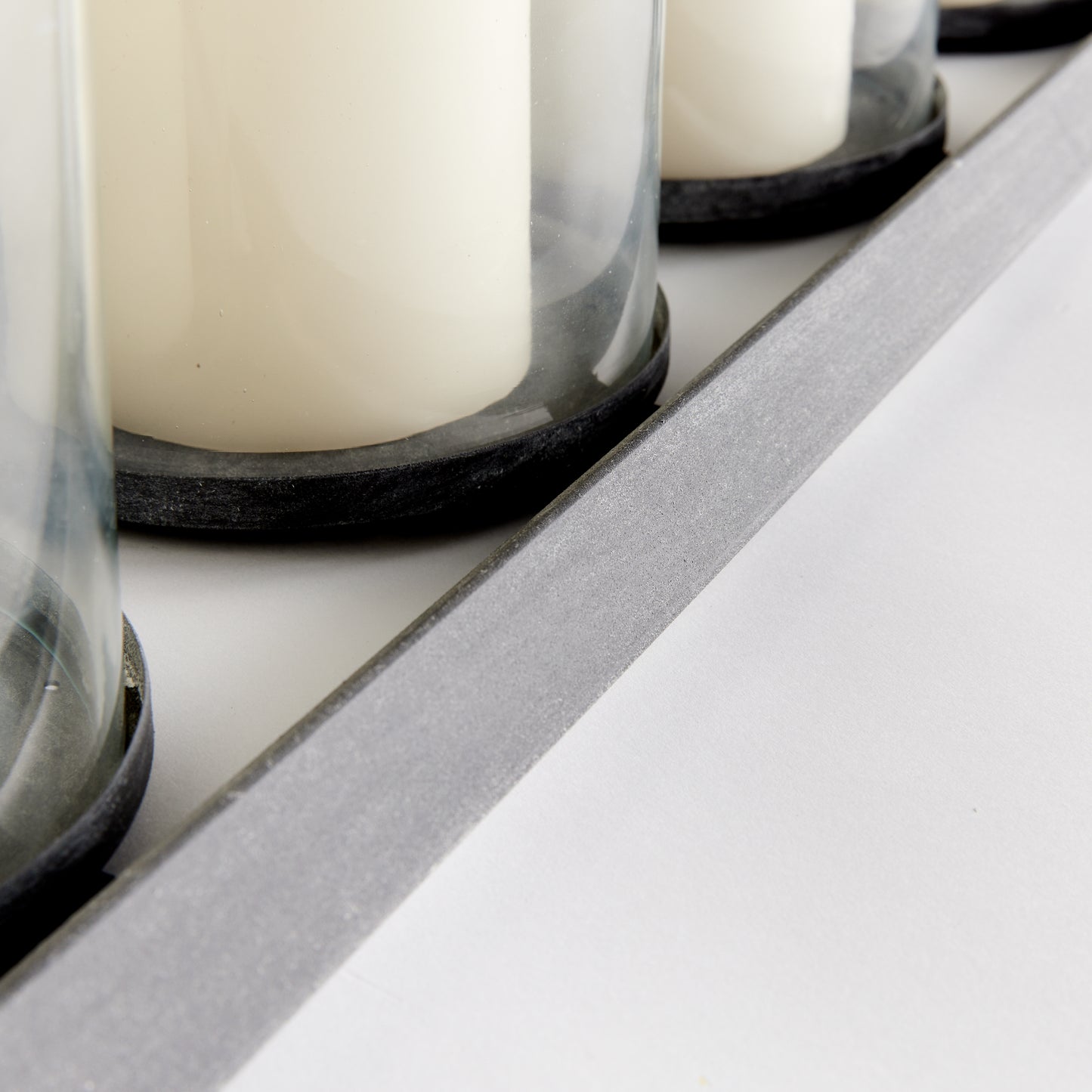 Professionally designed and expertly crafted, the Baxton 5-Pillar Candleholder boasts a stunning zinc finish and drainage holes for added durability. Its timeless design and functional features ensure long-lasting beauty and functionality.