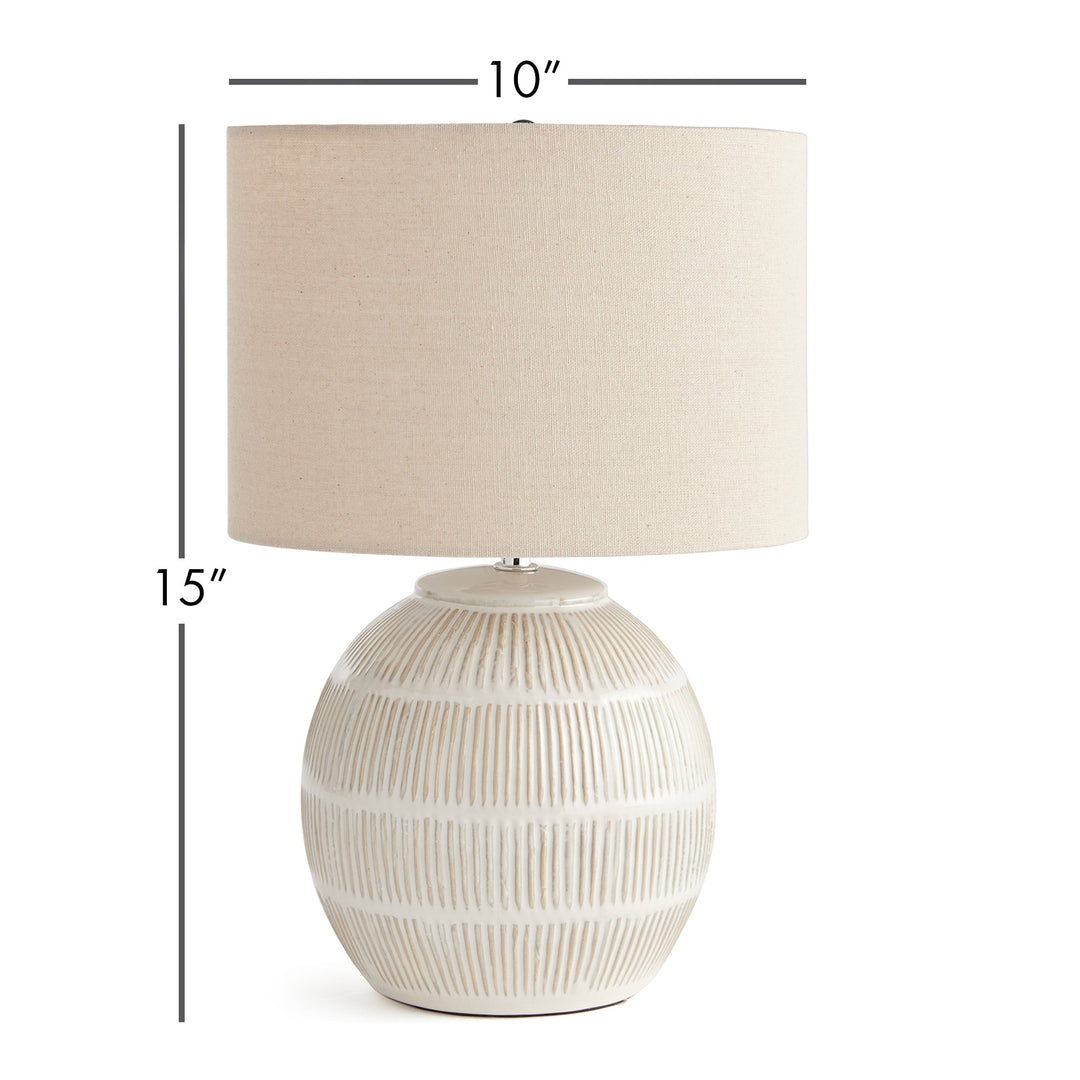 Featuring a rounded ceramic body with a hatch mark pattern, the Antoni White Table Lamp brings character to any space. The natural linen shade serves as a lovely accent on a bedside table, side table, or desk in a living room or dining area.