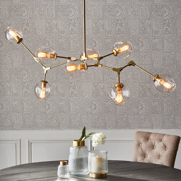 The Daniella Globe Chandelier Iron is a bold and modern addition to any living room or dining area. Crafted from iron and glass, with an antique brass finish, it boasts adjustable arms for a customizable twist. Create the perfect ambiance for any occasion with this stunning chandelier.