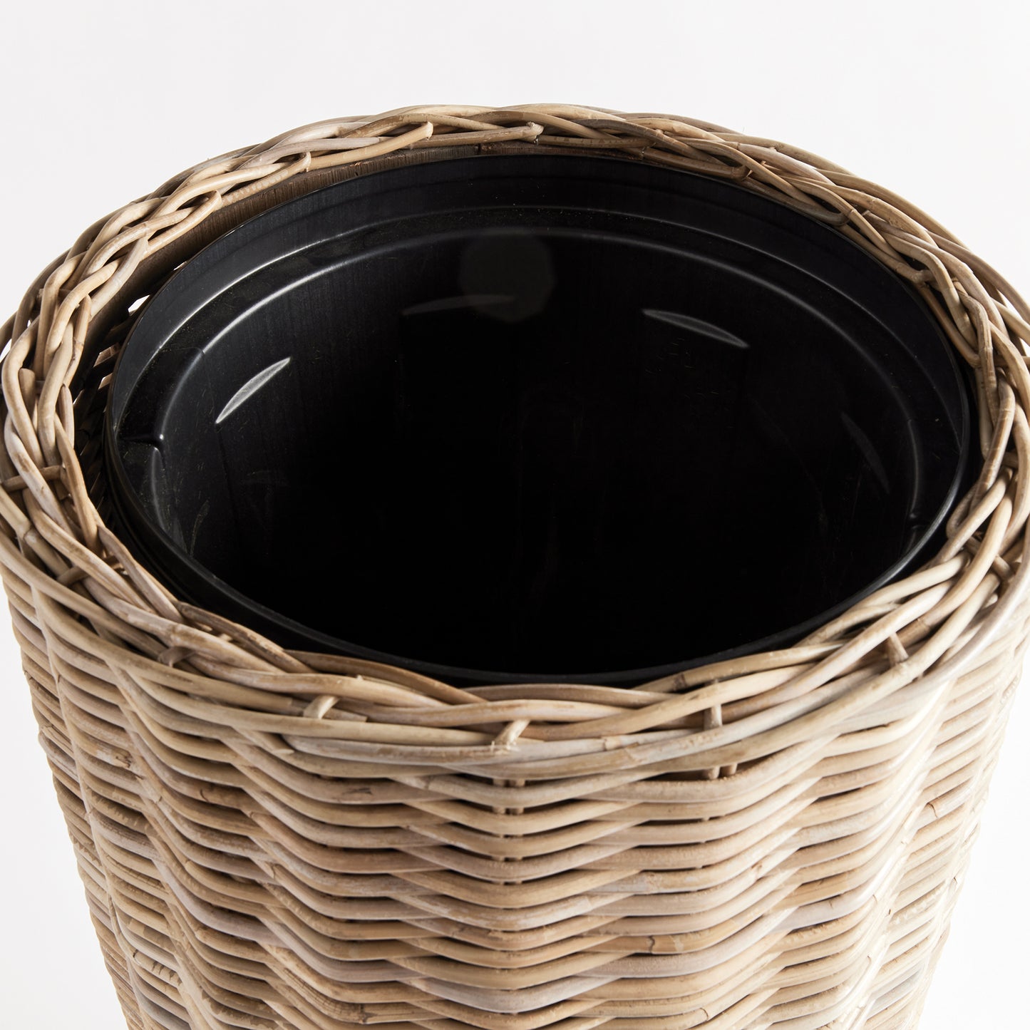 Discover the stunning beauty and unparalleled durability of this natural rattan planter. Its expertly crafted design features a distinctive flattened weave and sturdy iron frame, making it a must-have for both rattan enthusiasts and avid plant lovers alike. And with the included grower's pot, your plants will have the perfect foundation for optimal growth. Invest in the best with this tall rattan planter.