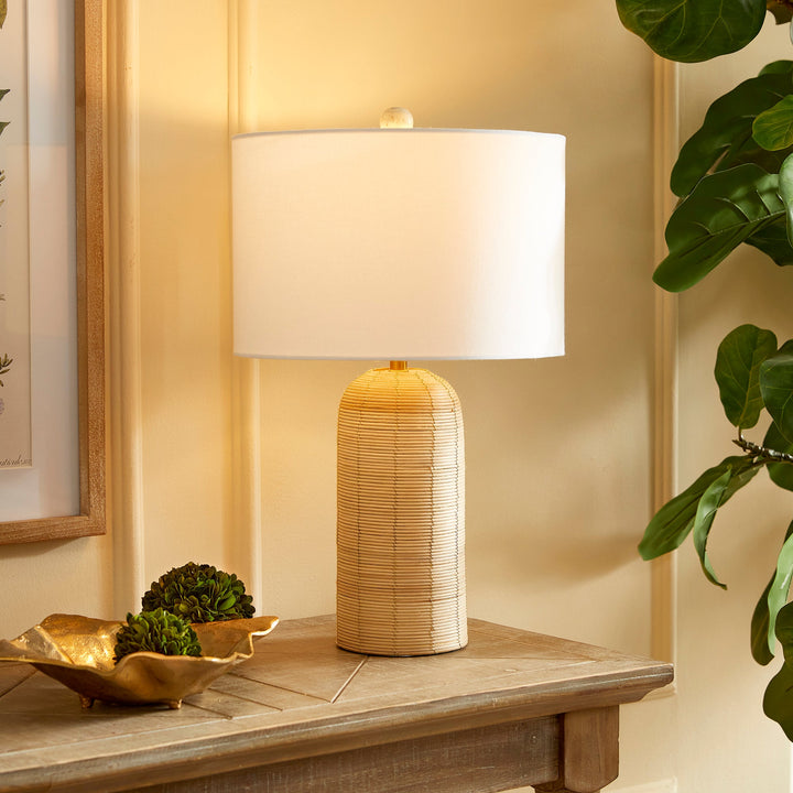 Crafted with a whitewashed cane rattan weave, this table lamp boasts individuality with its varying colors. It's a timeless piece, featuring a wide cylindrical shade that effortlessly complements any room, be it a bedroom, living room, or study.