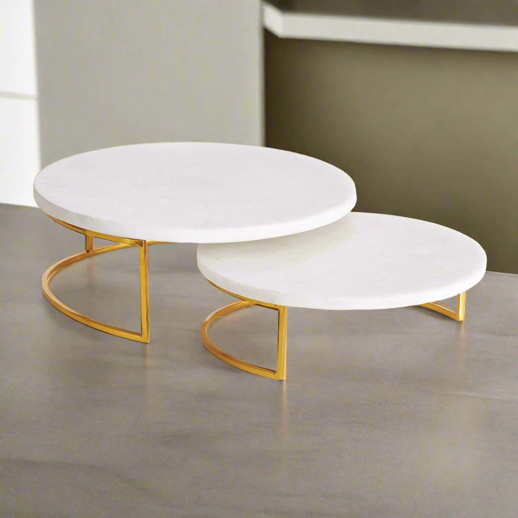 Enhance your serving experience with these sophisticated serving stands made from marble and brass, perfect for any occasion from coastal gatherings to traditional or transitional settings. The combination of marble and brass adds a touch of elegance to your favorite cheese and cracker spreads. Versatile yet timeless, these stands are a must-have for your serving collection.