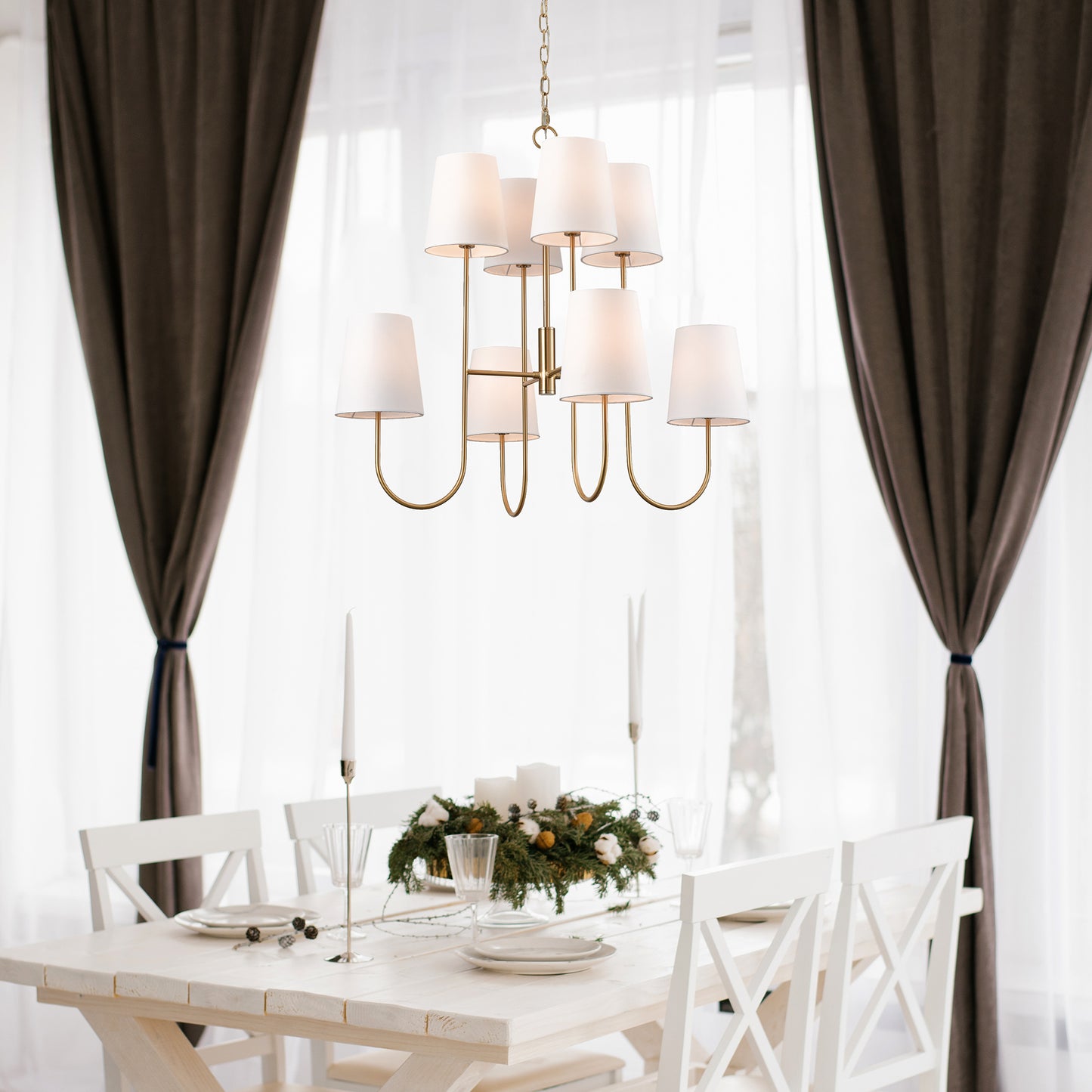 Enhance your living room or dining area with the Kinley Classic Gold Chandelier. The two-tiered shape and tapered shade adds a modern touch to the classic design. Crafted from iron with a sleek gold finish, this chandelier is hardwired and may require light assembly. Elevate your space with this elegant and stylish piece.