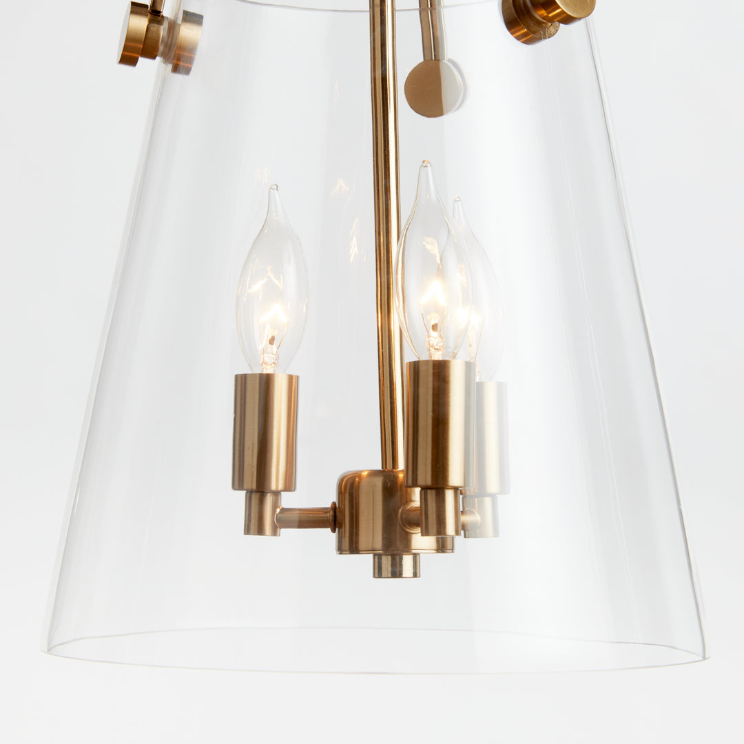 Crafted with a custom glass mold, the Capra Gold Chandelier Light Small boasts a clever design decision. The top gold metal detail passes through the glass, resulting in a distinctive appearance. Its iron and glass construction ensures a well-proportioned and durable chandelier. With a ceiling mount and the ability to hold three bulbs, this piece adds a touch of luxury to any space. Elevate your decor with this sophisticated and chic lighting option.