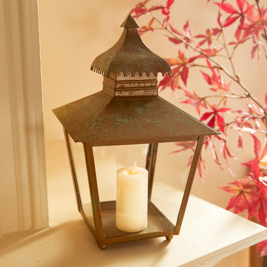 With its simple yet eye-catching design, the Anders Indoor Lantern Small adds a touch of elegance and charm to any indoor setting. The lantern features a curved pagoda and notched edge, giving it a unique character. Crafted from high-quality materials, it boasts a warm patina finish that adds a weathered look, making it suitable for any living space. Elevate the ambiance of your room with this beautifully crafted lantern that exudes sophistication.