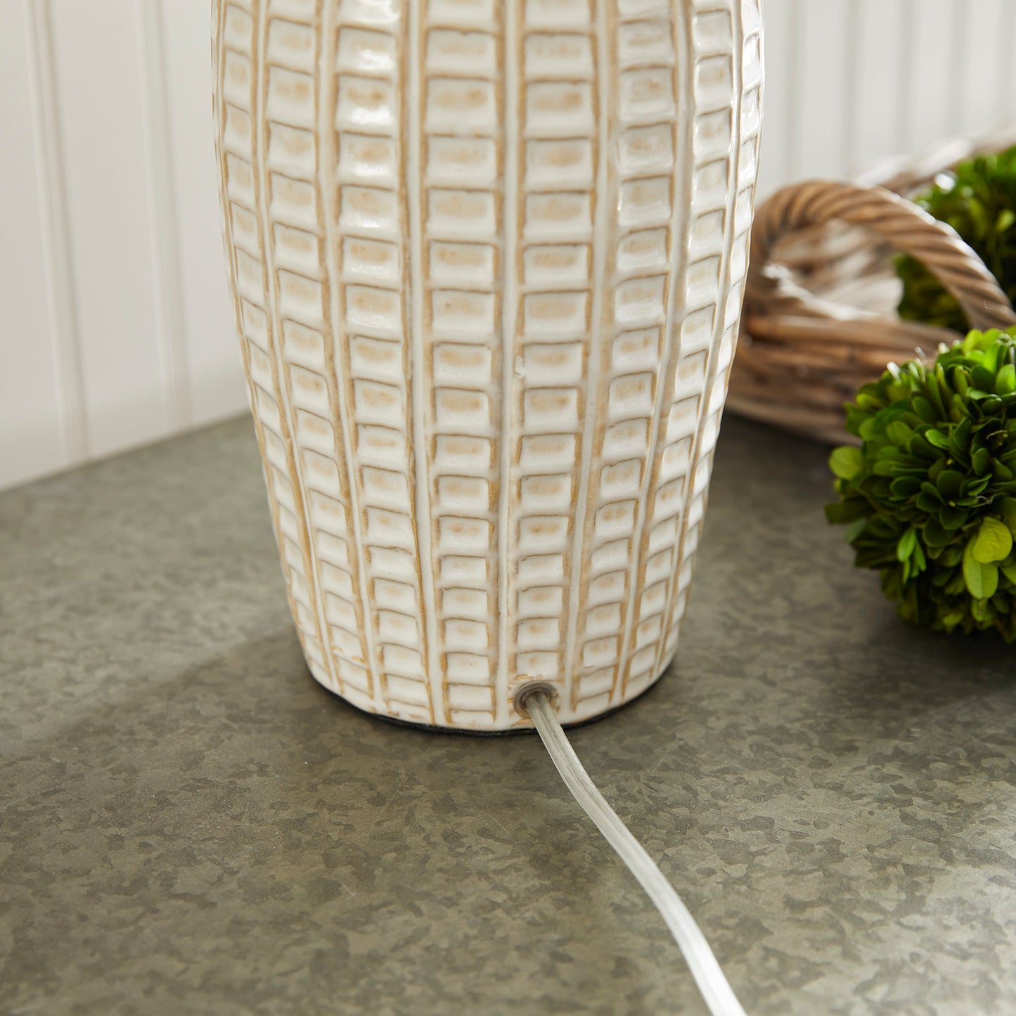 With a pressed pattern on the ceramic body, the Nadia Lamp is a work of art. Topped off with a generously scaled fabric shade, it is sure to enhance any space. intricate details, bold, finial, classic white, metal accents This ceramic lamp boasts an eye-catching pressed pattern and an elegantly designed fabric shade, making it an artistic addition to any room. With intricate details, a bold finial, and classic white coloring with metal accents, it offers both style and subtlety.