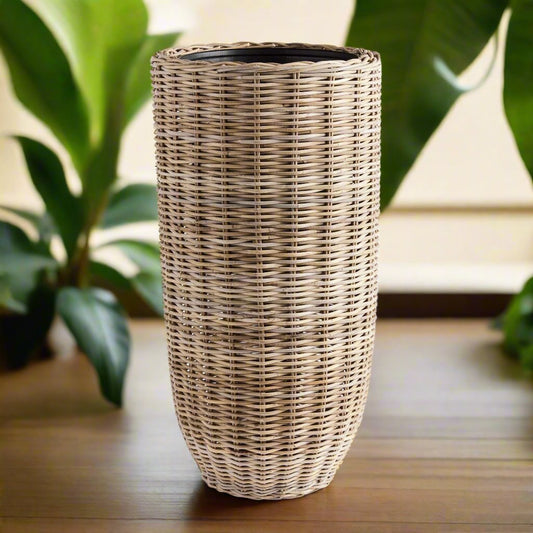 Discover the stunning beauty and unparalleled durability of this natural rattan planter. Its expertly crafted design features a distinctive flattened weave and sturdy iron frame, making it a must-have for both rattan enthusiasts and avid plant lovers alike. And with the included grower's pot, your plants will have the perfect foundation for optimal growth. Invest in the best with this tall rattan planter.