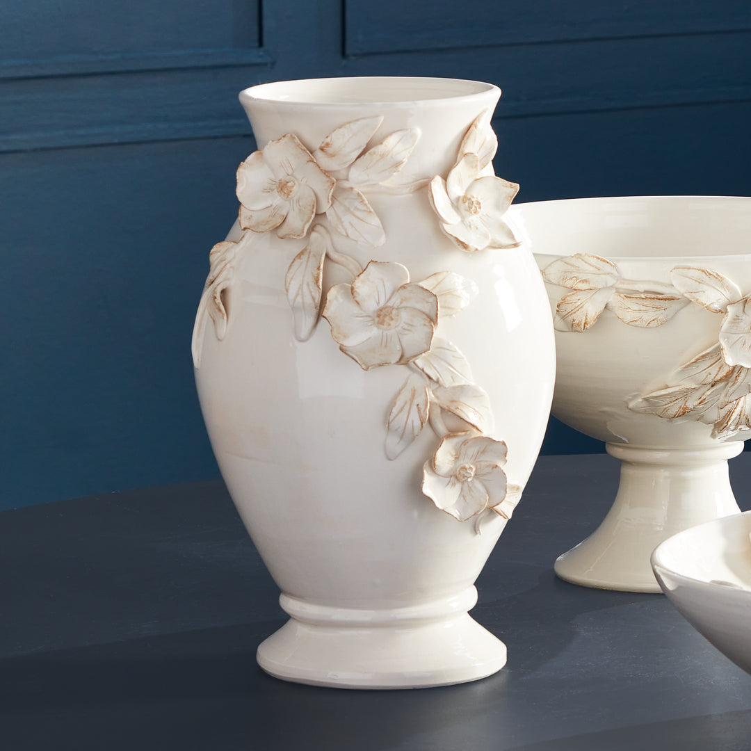 Expertly crafted by skilled Italian artisans in Tuscany, the Fiori Floral Vase showcases a seamless design in a soft white glaze with delicate antiquing on the petal edges. Each dogwood flower and leaf detail is meticulously handmade and hand-painted, making each piece a true original.