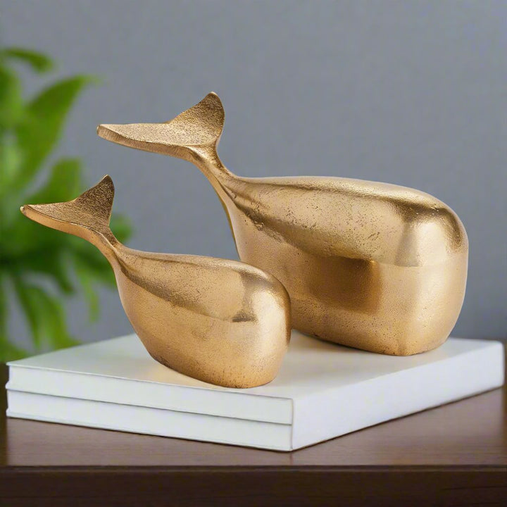 Add a touch of elegance to your coastal-inspired space with this sleek and modern set of Gold Whale Sculptures. Made from durable aluminum, these sculptures are a beautiful and charming accent for any shelf or surface. Whether for an art enthusiast or home decorator, these solid sculptures are sure to impress with their stunning design and construction.