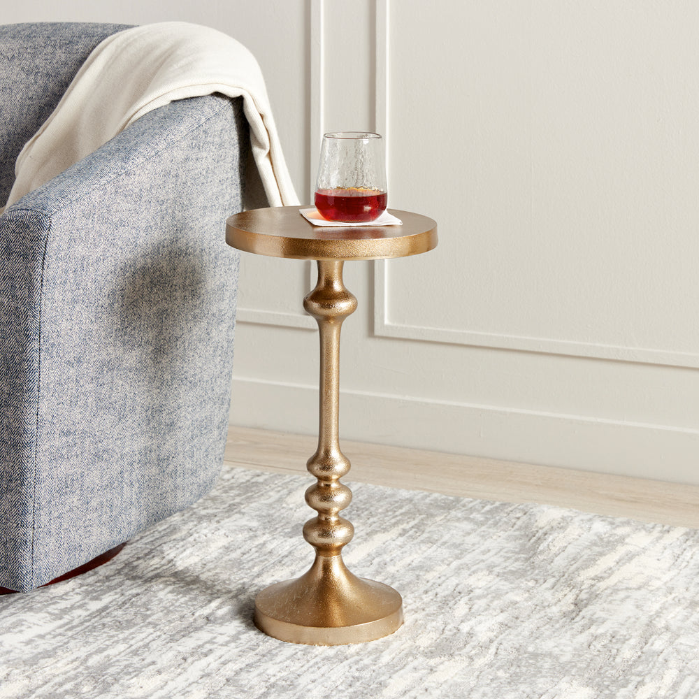 Featuring a sleek antique brass frame and a compact surface, the Bryce Brass Accent Table is a timeless addition to any contemporary living space. Its lightweight design allows for effortless portability, while its sturdy construction ensures stability for holding drinks, plates, and laptops with ease. Add both practicality and style to your home with this versatile and elegant accent table.