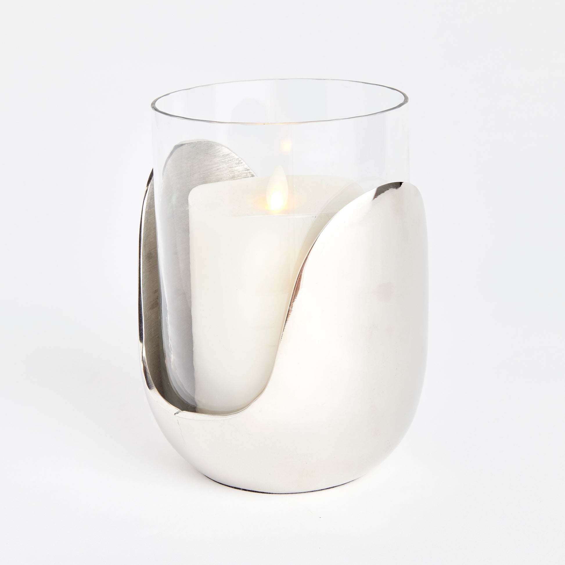 This exquisite hurricane is a beautiful blend of well-planned design and a variety of materials. It showcases hand blown glass that effortlessly fits into an abstract cast aluminum base with a sleek silver finish. Perfect for a side table, console, or mantel, this one-of-a-kind piece adds a touch of contemporary elegance to any space.