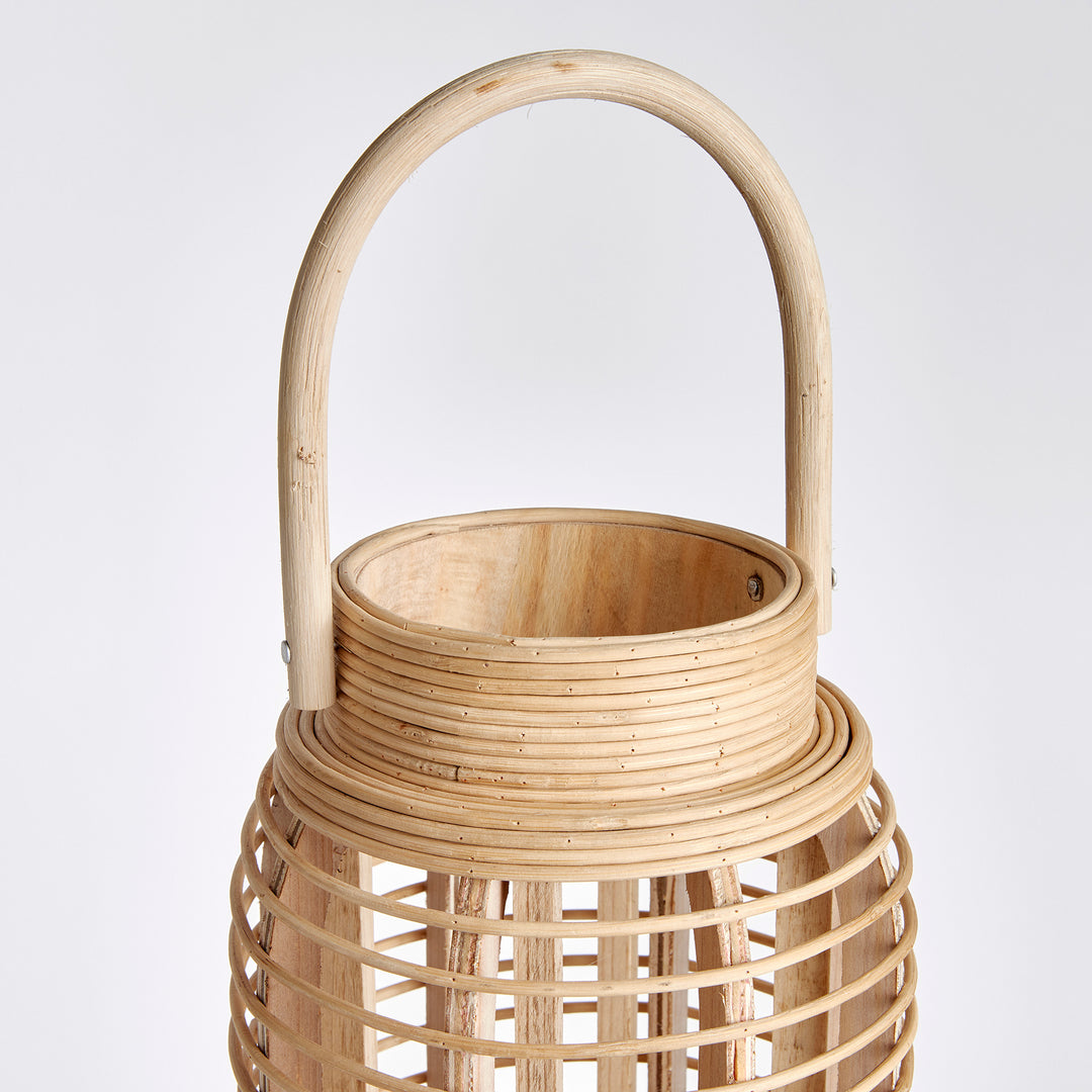 Crafted with expertise and sustainable bamboo, this lantern's tall and slender rattan body exudes natural elegance and makes a statement in any space. Whether in a coastal setting or as a stylish accent, its unique design adds a touch of nature to any room.