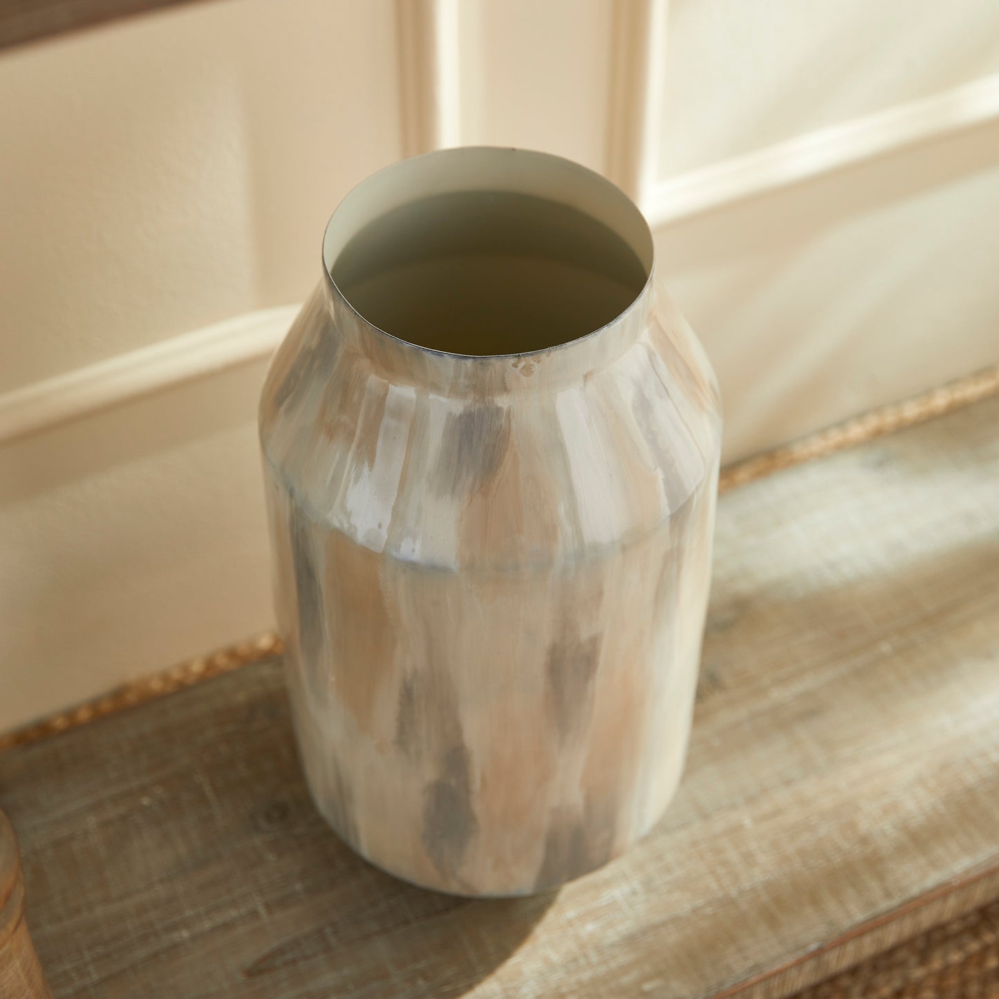 Add a touch of contemporary elegance to your décor with the Almeta White Pearl Decorative Jar Tall. This jar is expertly hand-painted with a delicate neutral tone-on-tone design, showcasing its lightweight enameled iron construction. It is the perfect addition to any modern space, offering sophistication and style in one beautiful piece.