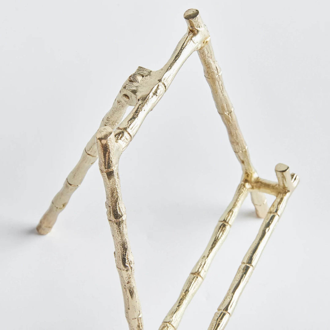 Constructed to hold platters, cookbooks, or a small work of art, this easel is both durable and sturdy. Its elegant gold bamboo accents offer a touch of classic charm, while providing versatility for showcasing your treasured items. With a seamless blend of traditional aesthetics and modern practicality, this easel is a formidable choice.