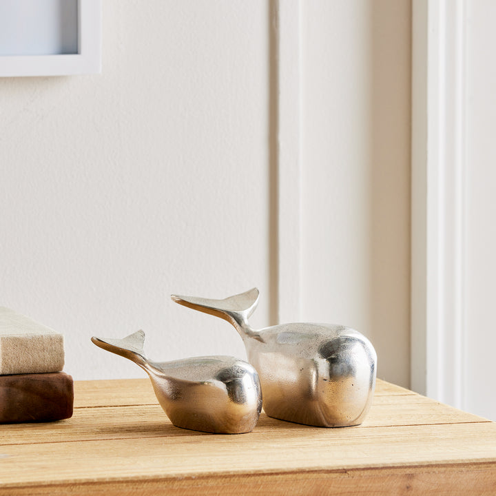 Expertly crafted from solid aluminum, these modern whale sculptures exude charm and coastal vibes. While smaller in size, they make a great shelf accent and add character to any space. Experience the durability and sleek design of these refined sculptures.