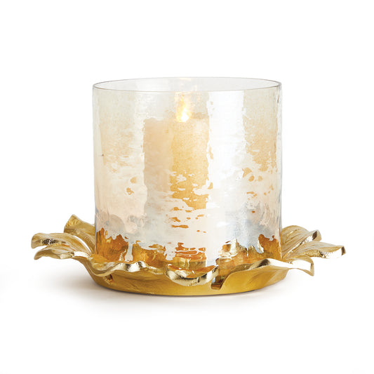 With an ombre hammered glass hurricane in a warm amber tone, atop a  cast-aluminum flowering petal tray, this is a signature accent piece for the home. Simply add a flickering candle and enjoy the warm glow.