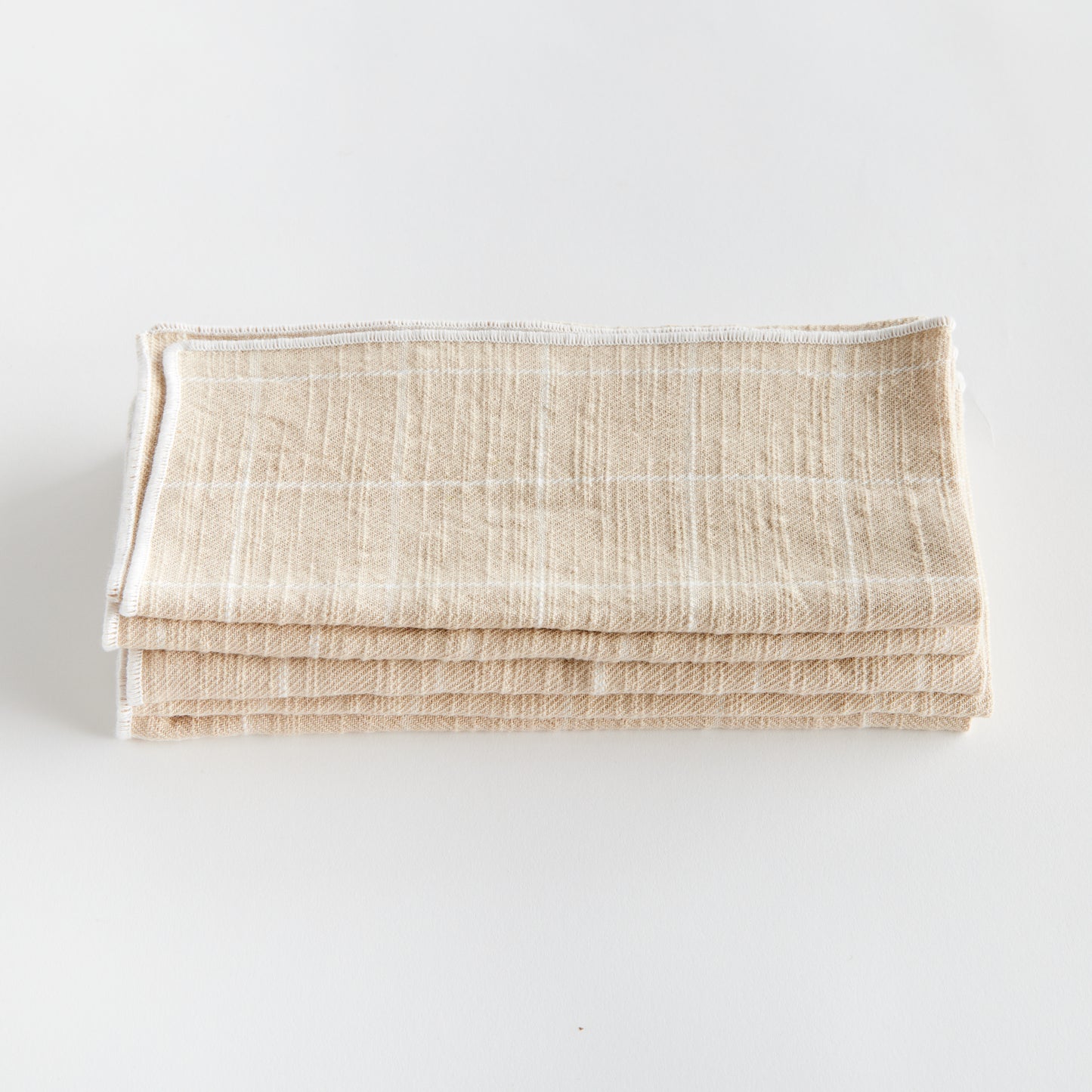 These four cotton napkins add a touch of softness to your table. The beautiful and textured soft taupe is designed to match any tablescape. Made of 100% cotton, they offer a luxurious and high-quality dining experience. The neutral taupe color seamlessly complements any table setting, enhancing both style and functionality for your meals.