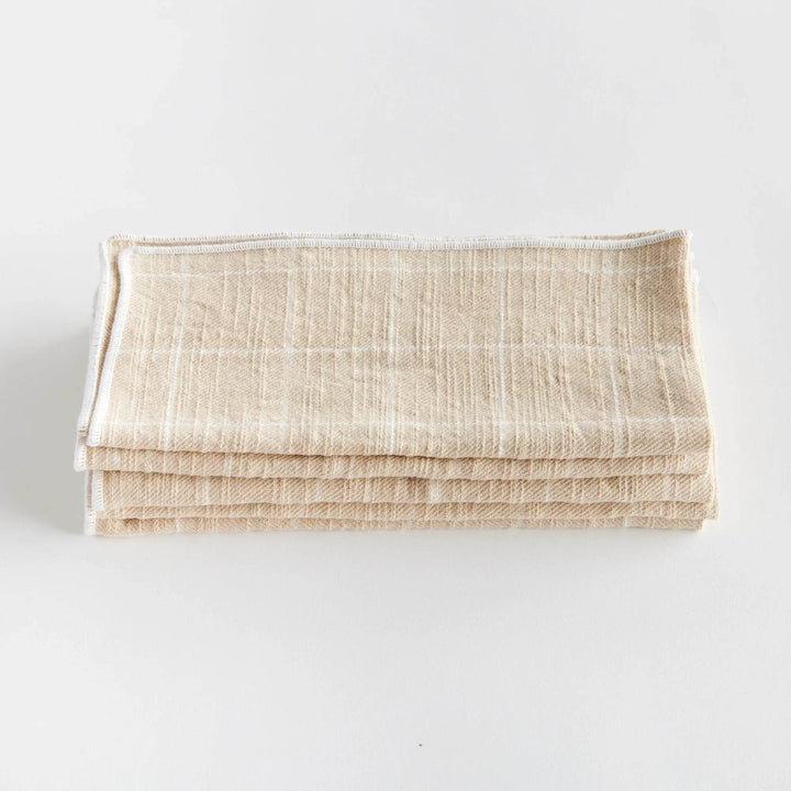 These four cotton napkins add a touch of softness to your table. The beautiful and textured soft taupe is designed to match any tablescape. Made of 100% cotton, they offer a luxurious and high-quality dining experience. The neutral taupe color seamlessly complements any table setting, enhancing both style and functionality for your meals.