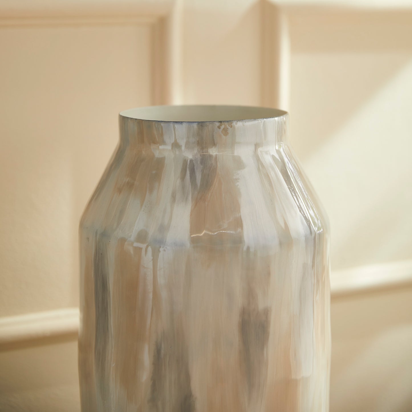 Add a touch of contemporary elegance to your décor with the Almeta White Pearl Decorative Jar Tall. This jar is expertly hand-painted with a delicate neutral tone-on-tone design, showcasing its lightweight enameled iron construction. It is the perfect addition to any modern space, offering sophistication and style in one beautiful piece.