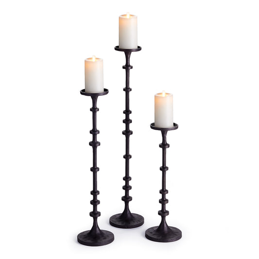 Expertly crafted from durable black bronze, the Abacus Black Bronze Candle Stands offer a modern and sophisticated touch to any living space. With their substantial size and nod to traditional counting methods, these candleholders are a must-have for mantle or front entryway display. Elevate your decor with this set of three candle stands that add a touch of elegance and modernity.