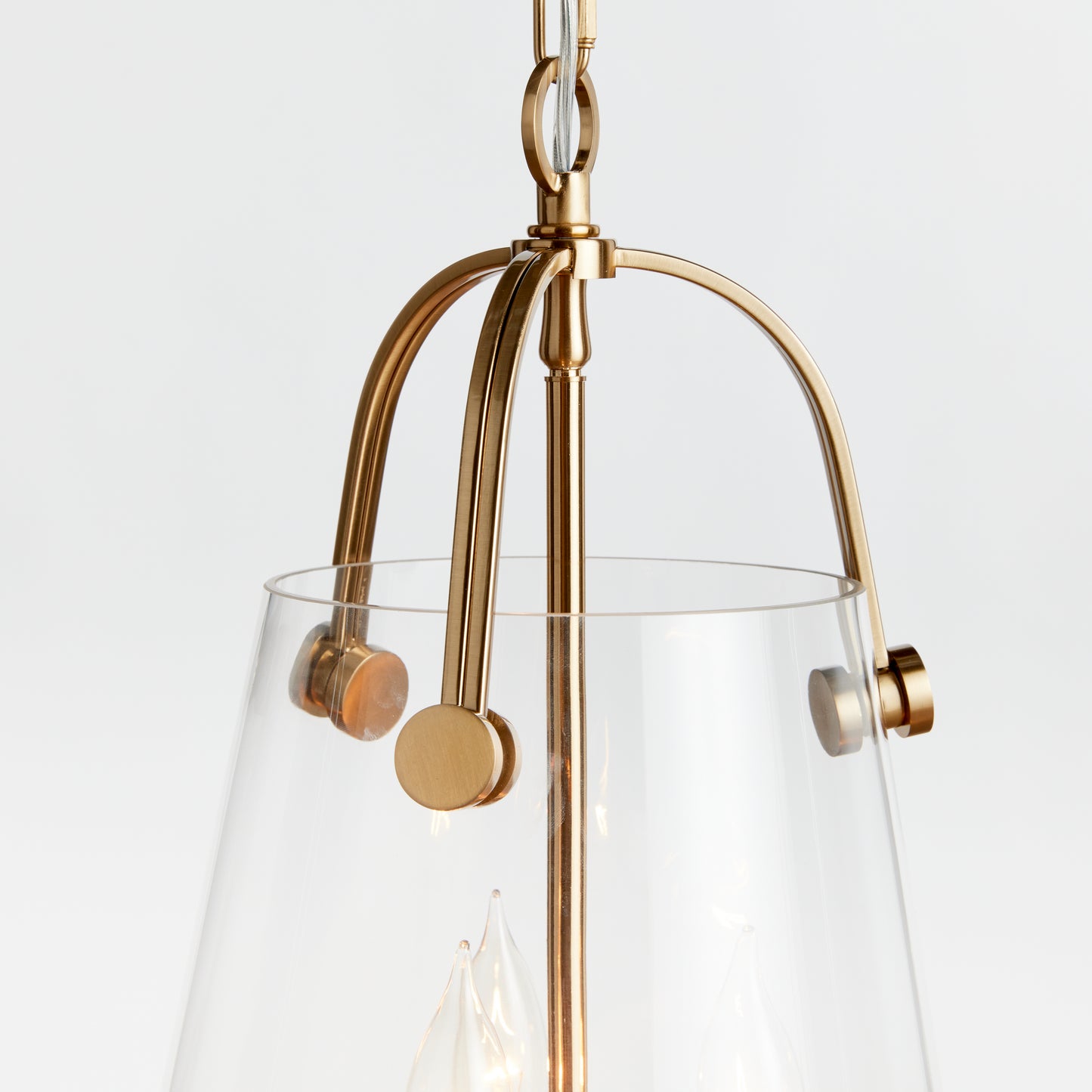 Crafted with a custom glass mold, the Capra Gold Chandelier Light Small boasts a clever design decision. The top gold metal detail passes through the glass, resulting in a distinctive appearance. Its iron and glass construction ensures a well-proportioned and durable chandelier. With a ceiling mount and the ability to hold three bulbs, this piece adds a touch of luxury to any space. Elevate your decor with this sophisticated and chic lighting option.