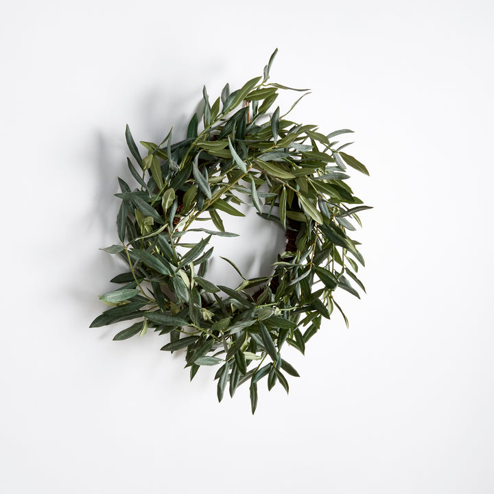 This olive wreath is a charming addition to any space needing a touch of warmth. Distinctive and refined, it's no wonder this Mediterranean beauty has stood the test of time. Comes complete with a twine loop for easy hanging. Use as a candle centerpiece on a table or hang on an interior door.