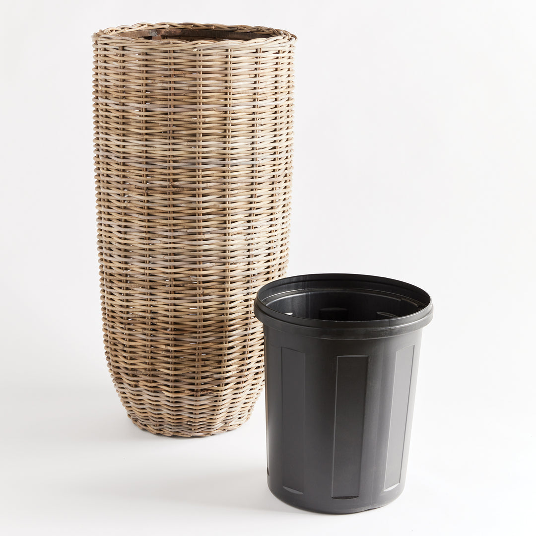 Discover the stunning beauty and unparalleled durability of this natural rattan planter. Its expertly crafted design features a distinctive flattened weave and sturdy iron frame, making it a must-have for both rattan enthusiasts and avid plant lovers alike. And with the included grower's pot, your plants will have the perfect foundation for optimal growth. Invest in the best with this tall rattan planter.